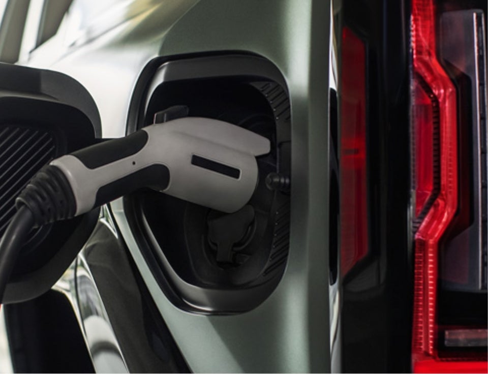 Close up of charging port with charger plugged in on a GMC Hummer EV SUV - Bynum GMC in Fayette Alabama AL